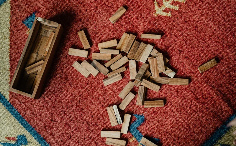 A graphic showing a stack of blocks labeled &ldquo;Problem exists,&rdquo; &ldquo;People want a fix,&rdquo; &ldquo;They&rsquo;ll pay,&rdquo; and &ldquo;I can reach them&rdquo; — balanced on a base labeled &ldquo;untested assumptions&rdquo;