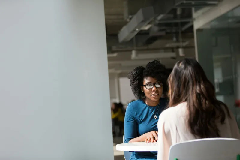 Two people in a productive conversation — the behavioral signals of genuine customer pain