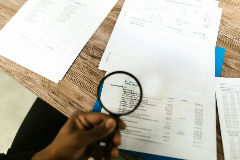 Detailed document review with a magnifying glass — the difference between real evidence and surface-level signals